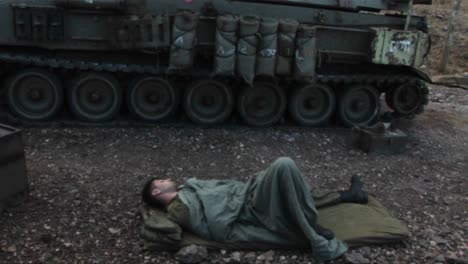 An-Israeli-army-soldier-sleeps-on-the-ground-next-to-his-tank-during-the-Israel--Lebanon-war