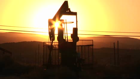 An-oil-derrick-pumps-at-sunset