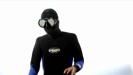 A-man-wearing-a-full-body-wetsuit-hood-and-goggles-practices-martial-arts