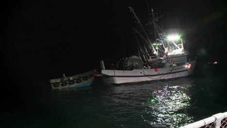 A-fishcutter-works-at-night-with-its-lights-on