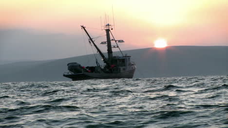 A-fishing-vessel-navigates-just-off-shore