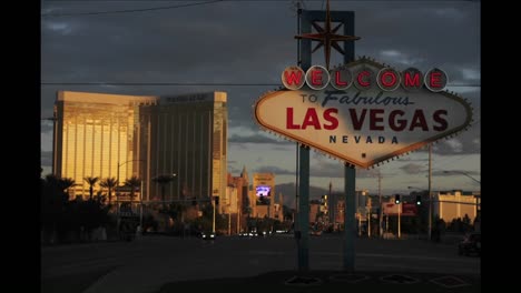 A-sign-welcomes-people-to-Las-Vegas-as-traffic-and-pedestrians-pass-by