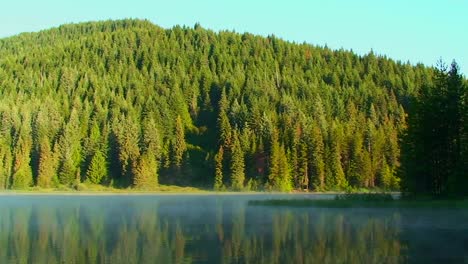 Steam-moves-across-Trillium-Lake-which-is-surrounded-by-pine-trees-and-near-Mt-Hood-in-Oregon