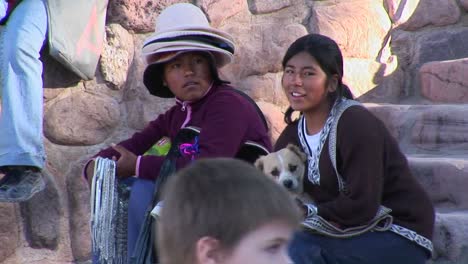 Latin-American-souvenir-sellers-hold-a-dog-at-a-tourist-attraction-in-South-America