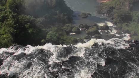A-moving-perspective-looking-over-the-edge-of-a-waterfall-Iguacu-Falls-1