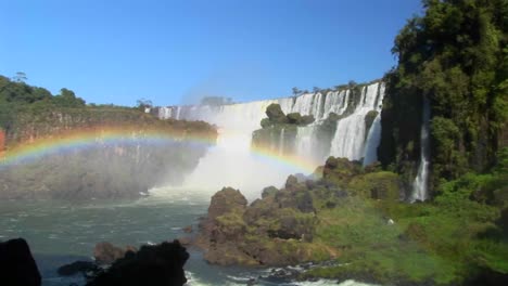 A-beautiful-wide-shot-of-Iguacu-Falls-with-a-rainbow-foreground