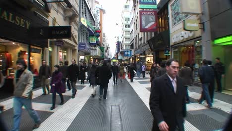 Shoppers-walk-down-a-crowded-busy-street