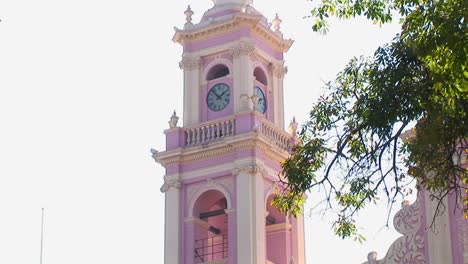 A-pink-clock-tower-displays-the-time