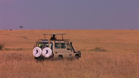 A-man-sits-in-a-parked-vehicle-on-the-plains-looking-around