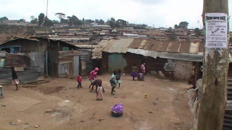 A-group-of-children-play-games-in-front-of-makeshift-homes-in-a-small-village
