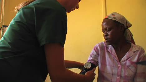 A-medical-worker-checks-the-blood-pressure-of-an-African-woman