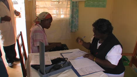 A-woman-receives-medication-and-consultation-from-medical-staff