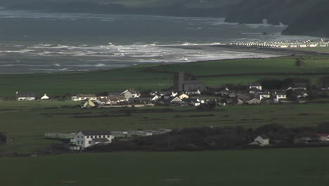 A-small-village-in-Ireland-with-the-coast-background