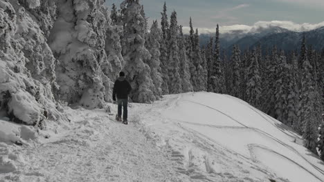 A-man-snowshoes-across-a-snowy-mountainside-1