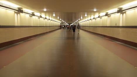 A-time-lapse-of-pedestrians-walking-through-a-long-hallway