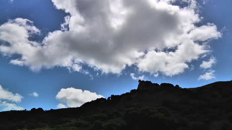 Time-lapse-of-clouds-passing-over-a-green-mountainside-