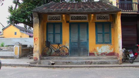 Menschen-Und-Fahrzeuge-Bewegen-Sich-Durch-Ein-Kleines-Gebäude-Im-Ländlichen-Vietnam
