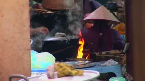 Fires-burn-and-a-pot-boils-as-Vietnamese-villagers-prepare-a-meal