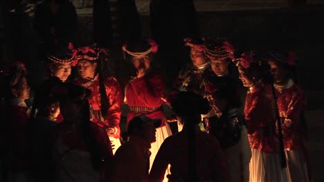 Ethnic-Chinese-gather-around-a-fire-at-night-for-a-ceremony