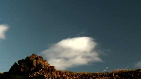 Clouds-float-over-the-top-of-a-mountain-in-time-lapse