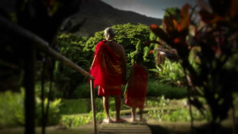 A-native-man-in-Hawaii-stands-in-a-field-and-a-child-suddenly-appears-next-to-him