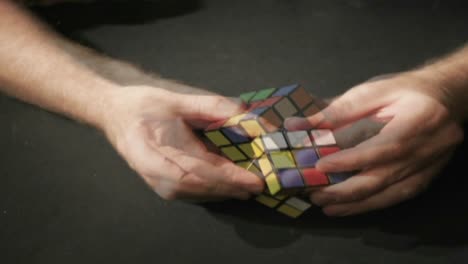 A-time-lapse-shot-of-hands-solving-a-Rubik's-Cube-puzzle