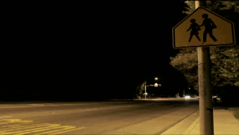 A-time-lapse-shot-at-night-of-traffic-passing-a-crosswalk