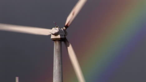 Tilt-up-to-gorgeous-rainbows-illuminate-wind-powered-generators-spinning