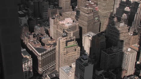 The-Empire-State-Building's-shadow-falls-on-several-smaller-buildings-below
