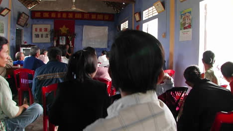 A-woman-speaking-Vietnamese-in-front-of-a-seated-audience