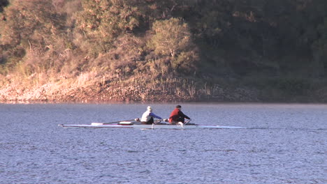 Panning-two-people-rowing-a-double-scull-on-Lake-Casitas-in-Oak-View-California