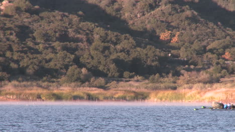 An-eight-person-rowing-sweep-being-followed-by-their-coach-on-Lake-Casitas-in-Oak-View-California