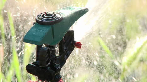 Closeup-rack-focus-on-a-sprinkler-spraying-water-in-Oak-View-California