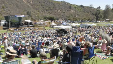 Zoom-out-time-lapse-of-a-crowd-at-an-outdoor-concert-in-Ventura-California