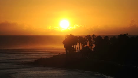 Close-up-time-lapse-with-slow-motion-of-sun-setting-in-the-clouds-over-Ventura-Point-in-Ventura-California