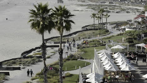 People-enjoying-the-bike-path-on-the-beach-in-front-of-the-Hotel-Del-Coronado-in-San-Diego-California