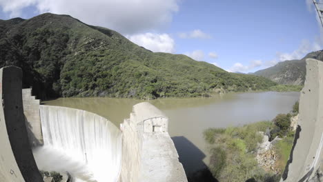 Wide-time-lapse-dolly-shot-from-above-Matilija-Creek-spilling-over-an-obsolete-Matilija-Dam-1