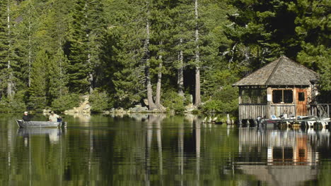 A-fishing-boat-leaving-the-Lower-Sardine-Lake-boathouse-near-the-Sierra-Buttes-in-Tahoe-National-Forest-California