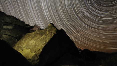 Time-lapse-star-trail-streaks-over-a-sacred-Owens-Valley-Paiute-petroglyph-site-in-the-Eastern-Sierras-California
