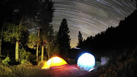 Time-lapse-star-trail-streaks-over-two-lite-tents-in-Big-Meadow-in-Sequoia-National-Forest-near-Kernville-California