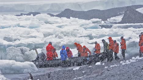 Tourists-entering-a-zodiac-in-a-snowstorm-at-Brown-Bluff-in-Antarctica