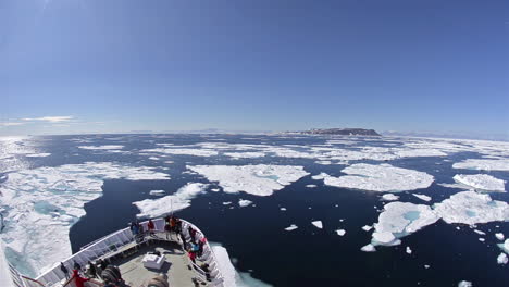 A-ship-travels-through-the-northwest-passage-in-East-Greenland-with-icebergs-surrounding