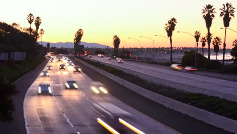 Time-lapse--cars-travel-on-a-freeway-at-sunset-or-dusk