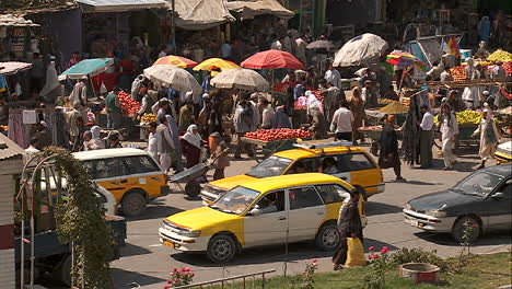 Taxis-and-vehicle-traffic-near-a-busy-fruit-market--in-Kabul-Afghanistan