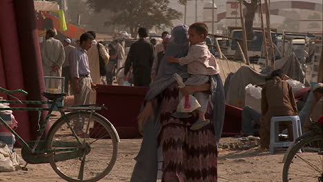 Slow-mo-shot-of-a-woman-in-burka-walking-with-her-child-in-Kabul-Afghanistan