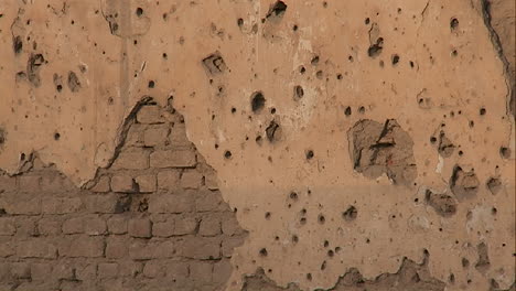 Tilt-up-of-bullet-holes-in-a-wall-in-Kabul-Afghanistan
