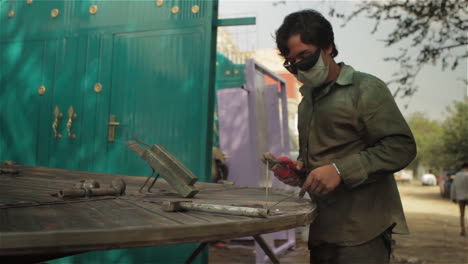 A-worked-does-spot-welding-in-an-outdoor-metal-shop-in-Afghanistan