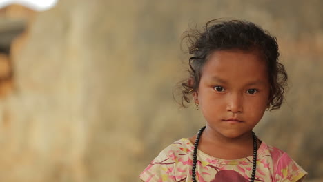 A-small-Nepalese-young-girl-looks-at-the-camera