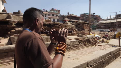 A-monk-walks-through-the-ruins-of-Kathmandu-following-the-earthquake-in-Nepal-in-April-2015