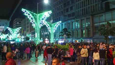 Crowds-of-people-walk-in-a-downtown-shopping-district-in-Bogota-Colombia-at-night